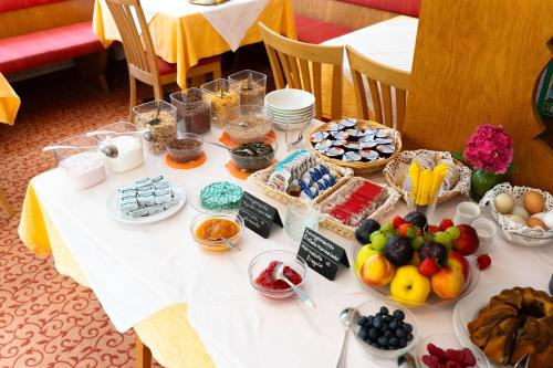 a table with food and desserts on it at Pension Baumgarten in Naturno