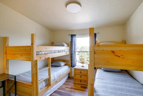 two bunk beds in a room with a window at Moab House Near Arches Natl Park and Canyonlands! in Moab