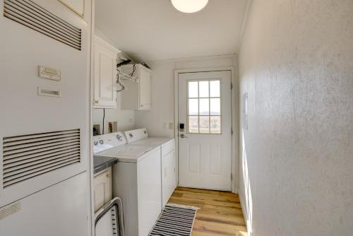 a kitchen with white cabinets and a window at Moab House Near Arches Natl Park and Canyonlands! in Moab