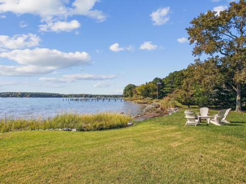 a group of chairs sitting on the grass by the water at Bankors Aweigh in Mount Pleasant