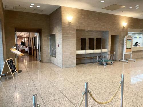 a lobby of a building with a bench in it at Smile Hotel Yonago - Vacation STAY 97655v in Yonago
