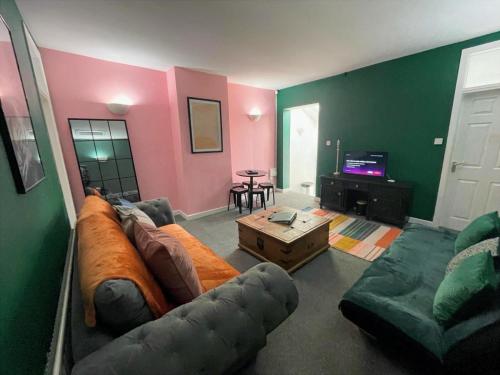 a living room with a couch and a table at The Hive at 205 in Manchester