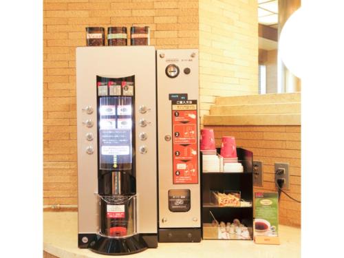 a vending machine with a drink dispenser on display at Smile Hotel Yonago - Vacation STAY 97656v in Yonago