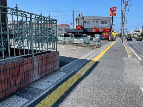 an empty street with a fence on the side of the road at Smile Hotel Yonago - Vacation STAY 97656v in Yonago