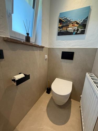 a bathroom with a toilet and a window at Tiroler Bergchalet bei Kitzbühel in Kirchdorf in Tirol