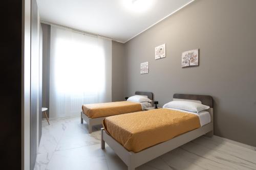 a bedroom with two beds and a window at Domus Aurea in Termoli