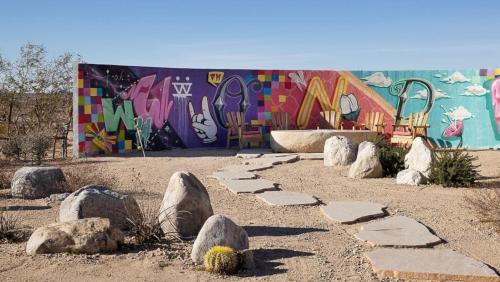 a building with a mural with rocks in a park at Beyond: Historic Rock & Roll Studio in Sunfair Heights