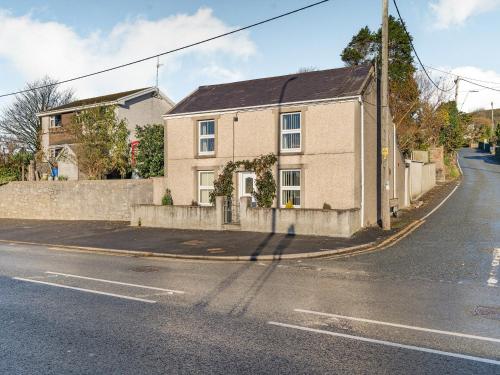 a house on the corner of a street at Rose Cottage in Pembrey