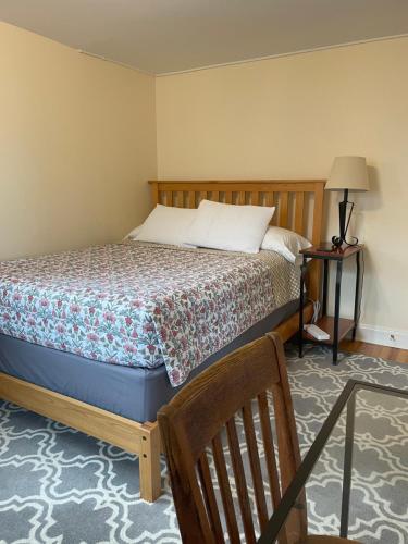 a bedroom with a bed and a table and a chair at The Lookout - Spacious Apartment in Superb Location in Burlington