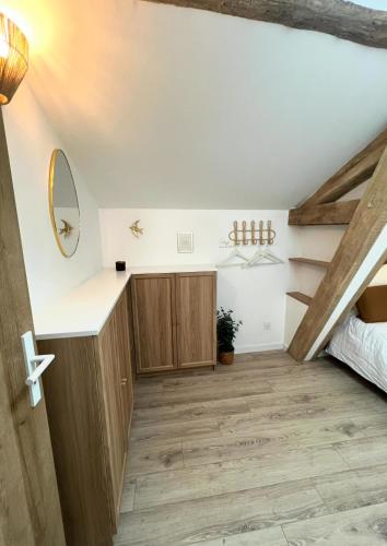 a room with a bed and a wooden floor at Serenity Appart', Les Clés de l'Espoir, proche Poitiers in Nieuil-lʼEspoir