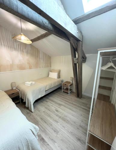 a bedroom with a bed and a bunk bed at Serenity Appart', Les Clés de l'Espoir, proche Poitiers in Nieuil-lʼEspoir