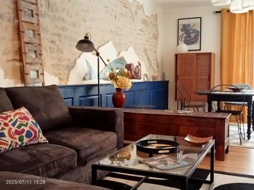 a living room with a couch and a table at Les Appartements du 31 - Centre Ville - 2è étage - 50 m2 in Quimper