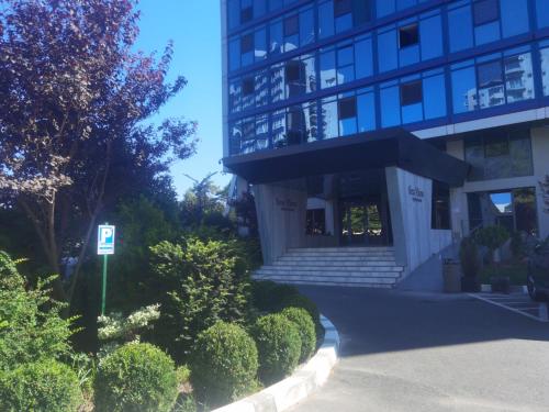 a building with a parking sign in front of it at Studio Olimp Sea View Apartments in Olimp