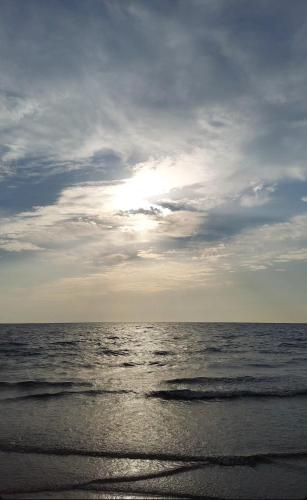 a beach with a cloudy sky and the ocean at Casa AnnaPaola Luxury in Chioggia