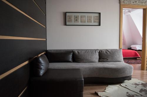 a living room with a couch and a mirror at Apartment 204 in Kopaonik