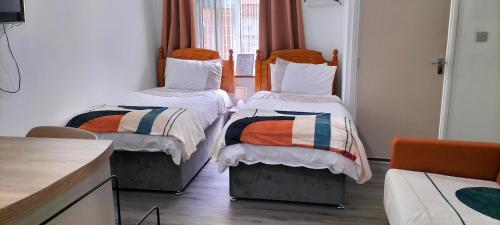 a room with two beds in a room at Blue Moon Self Catering Accommodation in Dunkineely