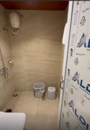 a small bathroom with a toilet in a room at Tekri Farms and Retreat in Ujjain
