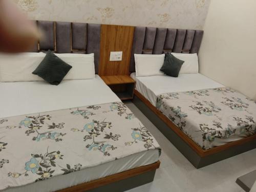 two beds in a small room withskirts at Grey stone stays-150 meters From Golden Temple in Amritsar