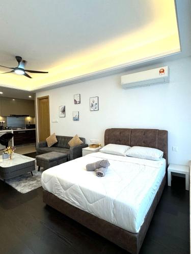 a bedroom with a large bed and a living room at R&F Princess Cove Swimming View By TGW STUDIO in Johor Bahru