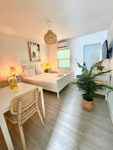 a bedroom with a bed and a table and a plant at Casa Agave Miami in Miami