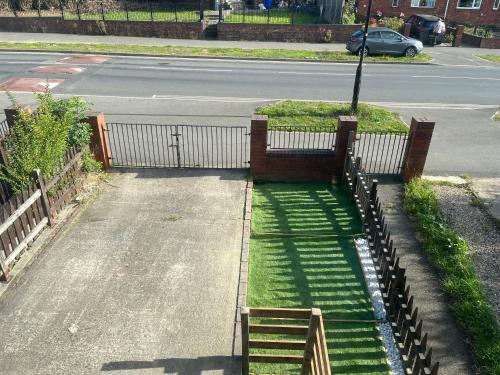 an empty street with a fence and grass at Cozy Private Blackout Room in Longley