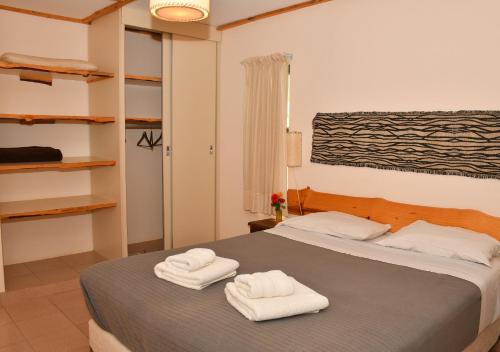 a bedroom with two towels on a bed at Aparts La Balconada by DOT Suites in Villa Pehuenia