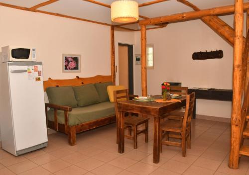 a living room with a table and a couch at Aparts La Balconada by DOT Suites in Villa Pehuenia