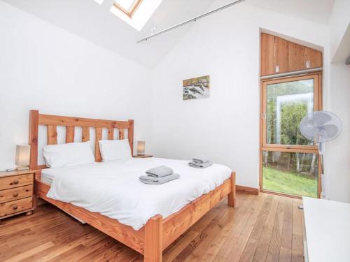 a bedroom with a bed and a window at Rathad An Drobhair in Garve
