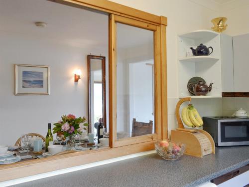 a kitchen with a large mirror on the counter at Dunyvaig in Colintraive