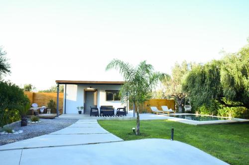 a house with a garden with a patio at Eléa Blu Pool & Garden in Afantou