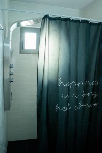a shower curtain with the words karma is a cure not shine at Eléa Blu Pool & Garden in Afantou