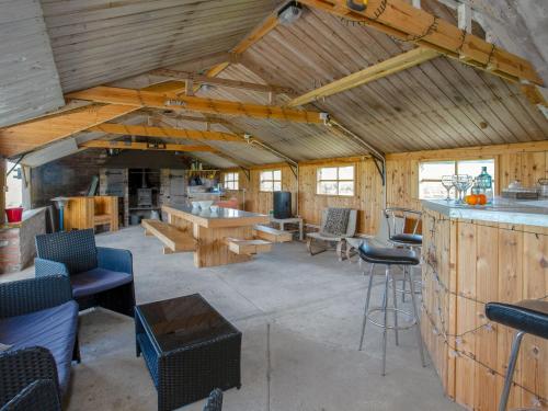 a large living room with wooden walls and a bar at Brens Barn in Bedale