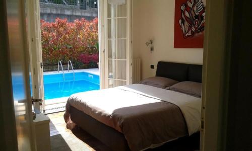 a bedroom with a bed and a view of a swimming pool at Villa Panoramica in Pozzolengo
