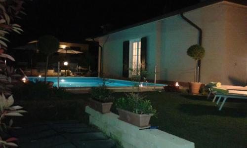a house with a swimming pool at night at Villa Panoramica in Pozzolengo