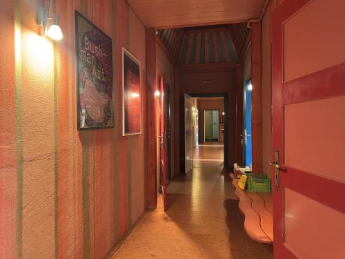 a hallway with red walls and a door and a hallway with a hallway at Gruppenhaus in Buntenbock in Buntenbock
