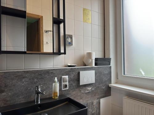 a bathroom with a sink and a mirror at Gruppenhaus in Buntenbock in Buntenbock