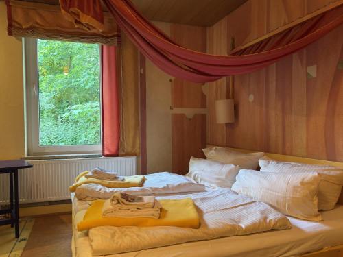 a bedroom with a bed with towels on it at Gruppenhaus in Buntenbock in Buntenbock