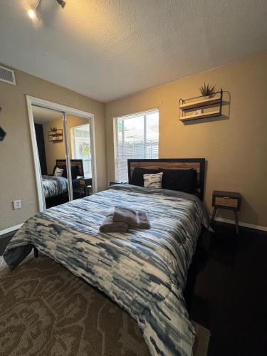 a bedroom with a large bed with a blue comforter at 5 STATE FAIR l DT Dallas l FIFA READY l Staycation 1Bd1Ba in Dallas