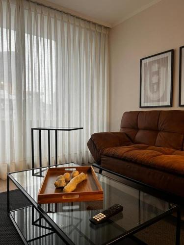 a living room with a couch and a coffee table at NM Departamentos Amoblados in Concepción
