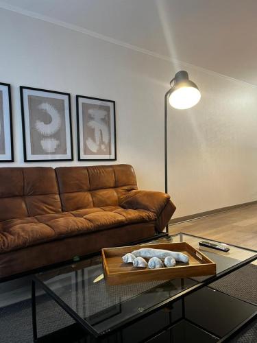 a living room with a couch and a glass table at NM Departamentos Amoblados in Concepción