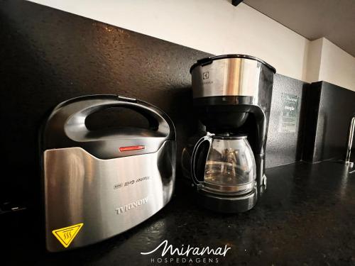 a coffee maker sitting on top of a counter at Get By Side - Jardim Oceania in Tambaú