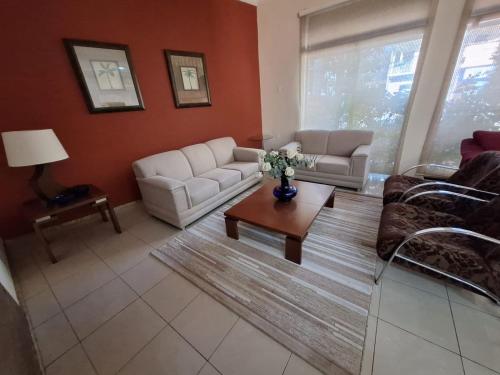 a living room with two couches and a coffee table at Hotel Itapema in Valinhos