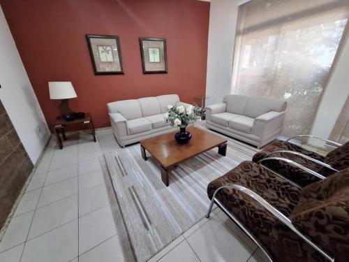 a living room with couches and a coffee table at Hotel Itapema in Valinhos