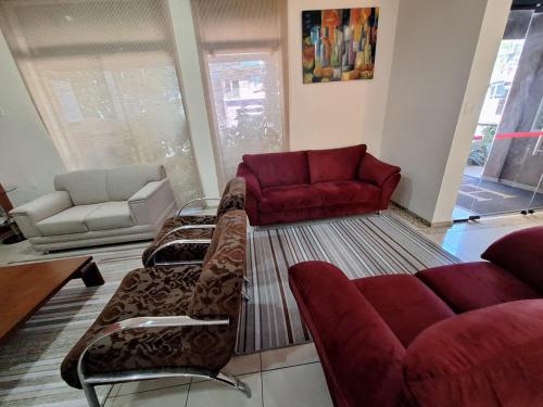 a living room with couches and chairs in a room at Hotel Itapema in Valinhos