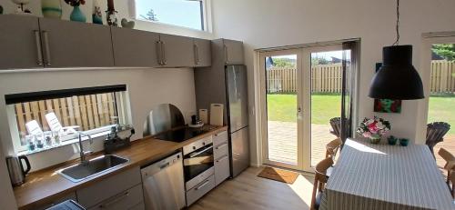 a kitchen with a sink and a counter top at Blokhus - tæt på by og strand in Blokhus