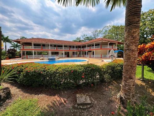 an exterior view of a resort with a swimming pool at Hotel Villa De Los Angeles in Villavicencio