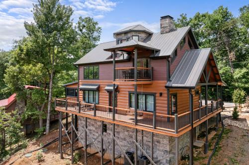 a house in the woods with a wrap around deck at High Fa-Lootin by American Patriot Getaways in Oldham