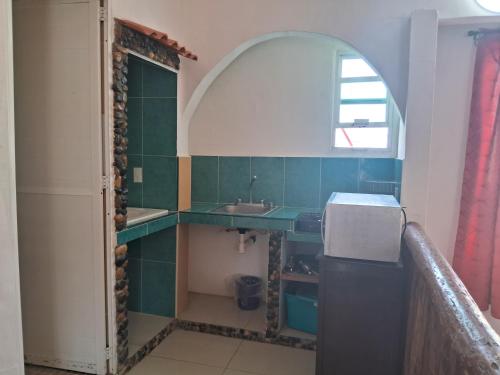 a bathroom with a sink and an archway at Hotel Villas del Rey in Chachalacas
