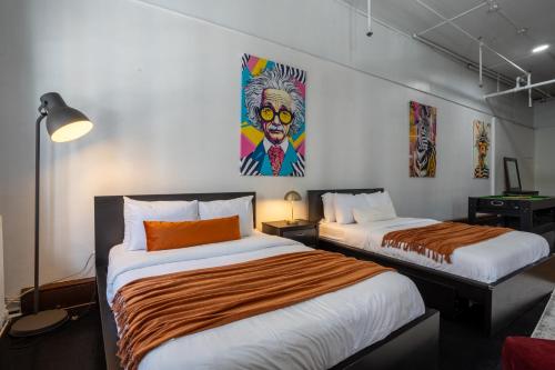 a room with two beds and a painting on the wall at 4 Stylish Lofts in Old Montreal in Montréal