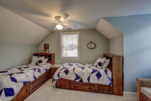 a bedroom with two beds and a clock on the wall at Spencer's Villa in Frisco